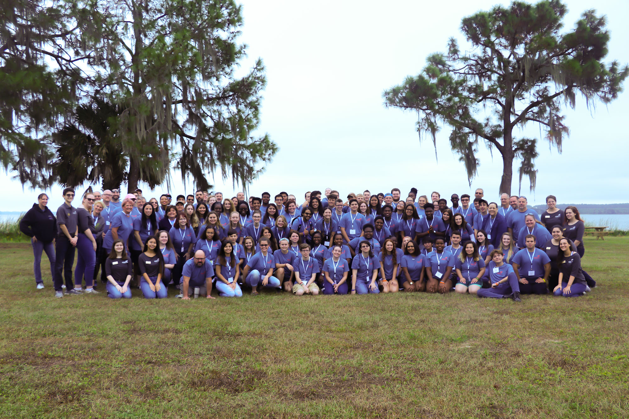 Large group of SkillsUSA Florida members posing in front of a body of water at a leadership conference